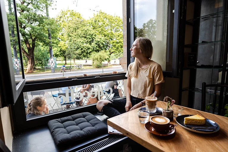 Eine Frau genießt Kaffee und Kuchen im Cafecello in der Dresdner Neustadt.